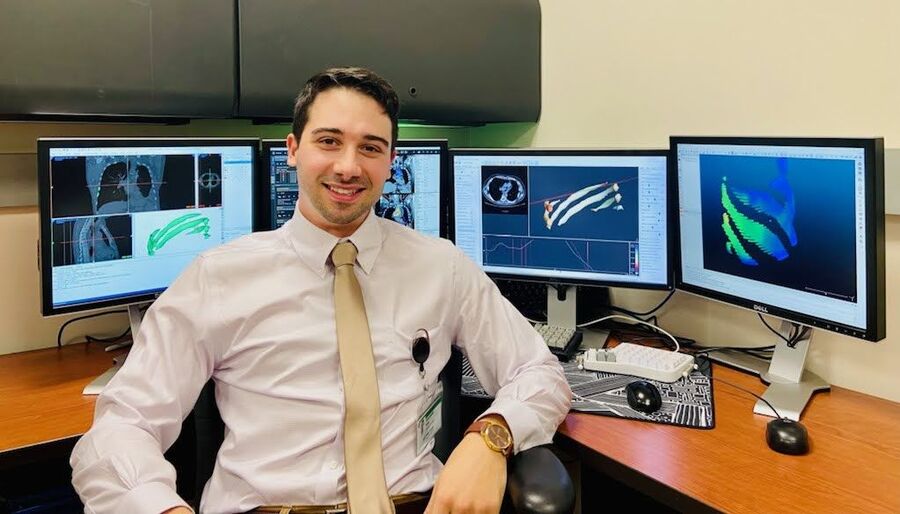 Alex Borg smiling at his desk