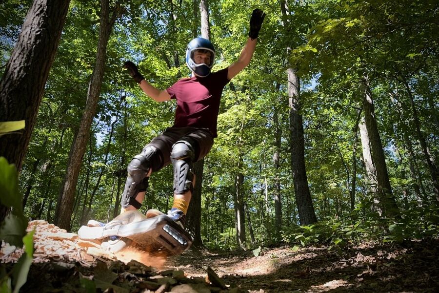 Cal Moody rides his Onewheel in the woods