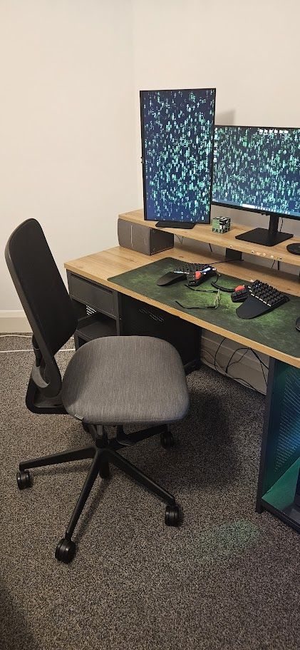 A chair and a coffee warmer see Maciej through long coding sessions Maciej Lech's desk