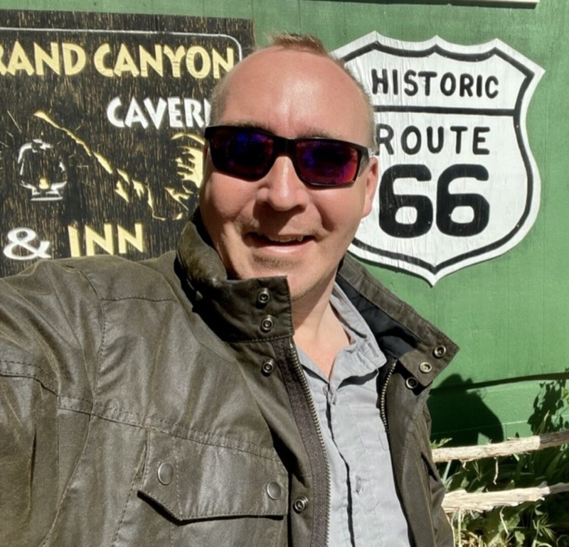 Charles Webster in front of a Route 66 sign