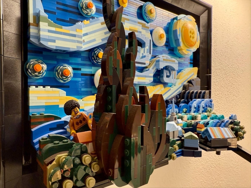 Sophia Wood's photo of Lego Bob Ross against a Lego Van Gogh painting