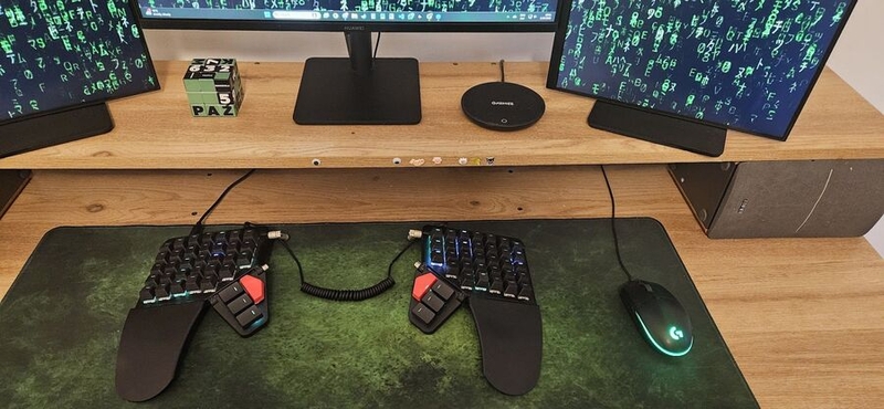 Maciej took several steps toward a split keyboard before opening his arms to one Maciej Lech's keyboard