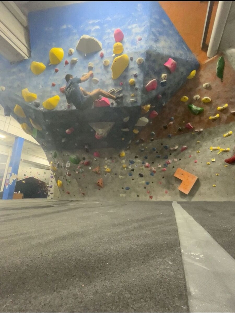 Raul Mendes on a rock-climbing wall