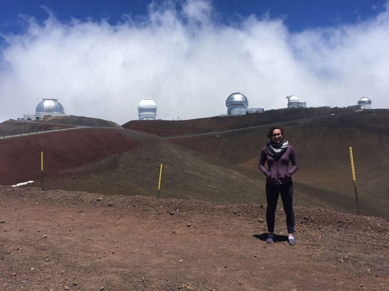 Erika Hamden with telescopes on Mauna Kea